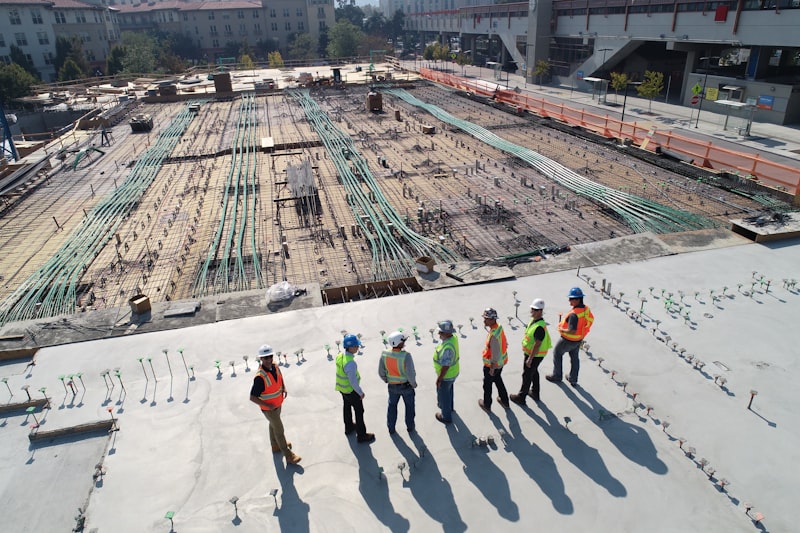 Workers in high-visibility clothing on an industrial site, seen from above — suggested image — client to supply the final photograph
